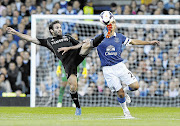FOCUSED: Chelsea's Juan Mata, left, challenges Everton's Leon Osman.