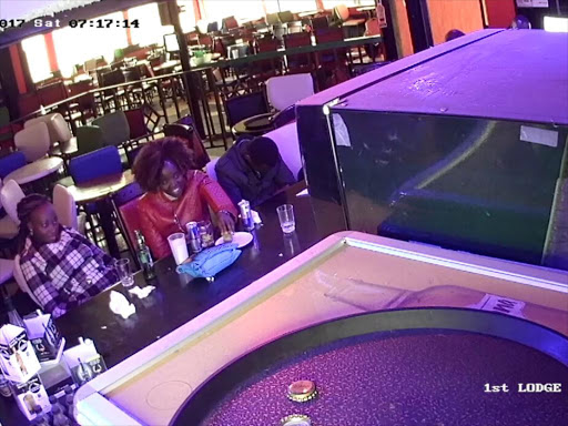 A CCTV grab showing the women seated at the counter after they joined the businessman who was seated on the left before they drugged him./COURTESY