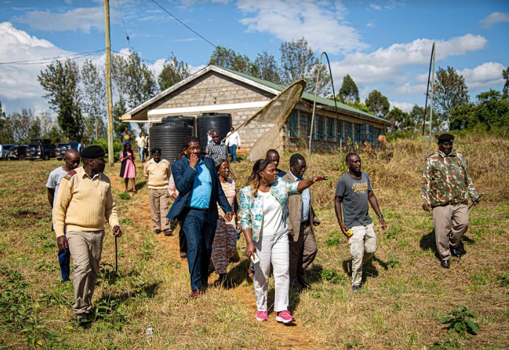 Pastor Dorcas (centre) walks at the Ngorano Vocational and Training Centre in Nyeri County, which is overrun with grass, and looks neglected.