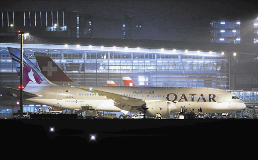 MAIDEN PASSAGE: Qatar Airways' new Boeing 787 Dreamliner aircraft parks after its arrival, for the first time, at Zurich Airport in Switzerland yesterday Picture: MICHAEL BUHOLZER/REUTERS