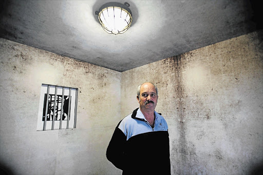 MINDER: Christo Brand in a reconstruction of a cell, part of an exhibition at Mandela Gateway, Cape Town. He was Nelson Mandela's jailer and later friend and was transferred with him to Pollsmoor Prison Picture: