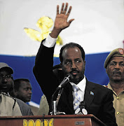 Somalia's newly elected President Hassan Sheikh Mohamud, a political newcomer, waves after emerging victorious in Monday's election in Mogadishu.