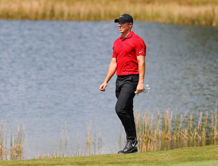 Rory McIlroy walks to the second green wearing red and black honoring Tiger Woods during the final round of World Golf Championships at The Concession golf tournament at The Concession Golf Club in Floridaa on February 28 2021.