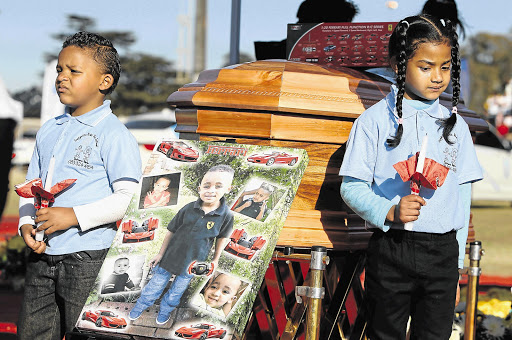HEARTBREAK: Parents Elwin and Chantel and sister Erin say their last goodbyes to four-year-old Taegrin Morris at the family home in Delmore Park on the East Rand before his funeral in Boksburg yesterday Picture: ALON SKUY