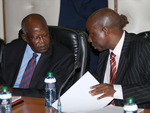 Suspended judge Philip Tunoi confers with his lawyer Fred Ngatia on May 31, during the hearing of the tribunal investigating his conduct in the Sh200 million bribery allegations /JACK OWUOR