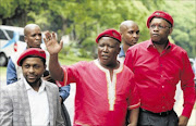 PAYING HOMAGE: EFF president Julius Malema, centre, with party leaders Mbuyiseni Ndlozi, left, and Dali Mpofu after visiting Jackie Selebi's home in Pretoria to offer  their  condolences 
      PHOTO: ANTONIO MUCHAVE