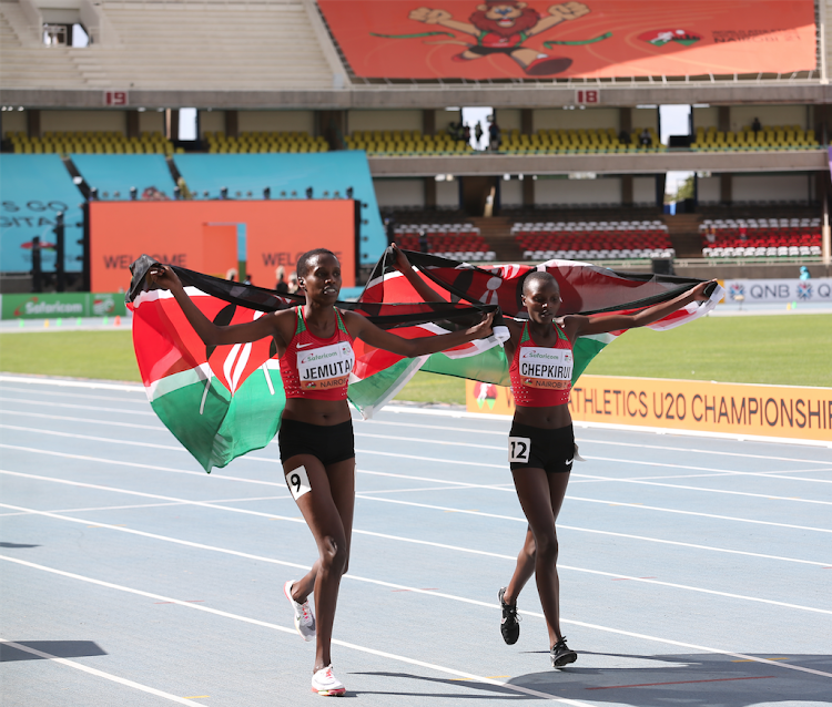 Purity Chepkirui and Winnie Jemutai celebrate after winning gold and bronze medals respectively in the 1,500m race during the World Under 20 Championships at Moi, Stadium, Kasarani
