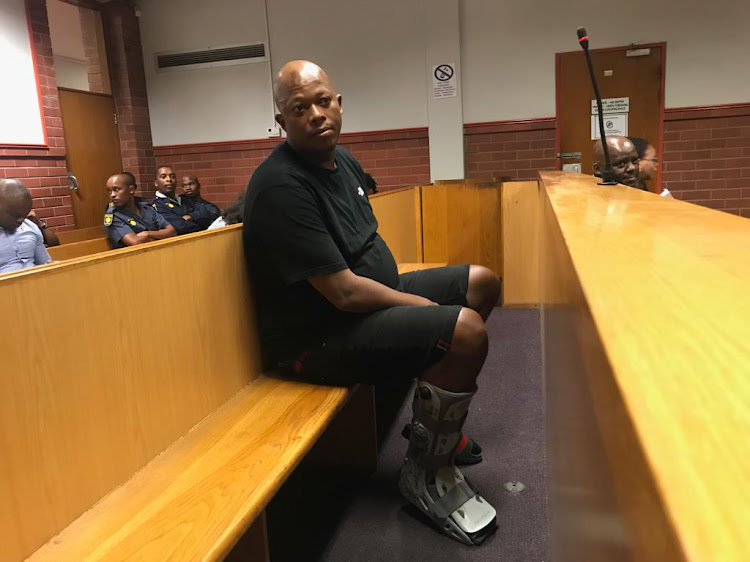 Mandla 'Mampintsha' Maphumolo appears in court with a cast on his right leg