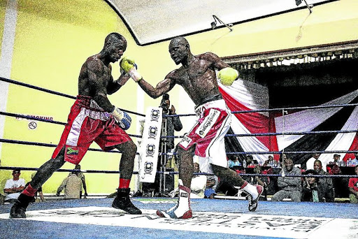 Tsiko Mulovhedzi of Limpopo, right, throws an uppercut to the face of Mziwoxolo Ndwayana of the Eastern Cape in a previous battle for the SA welterweight crown. /MARK ANDREWS