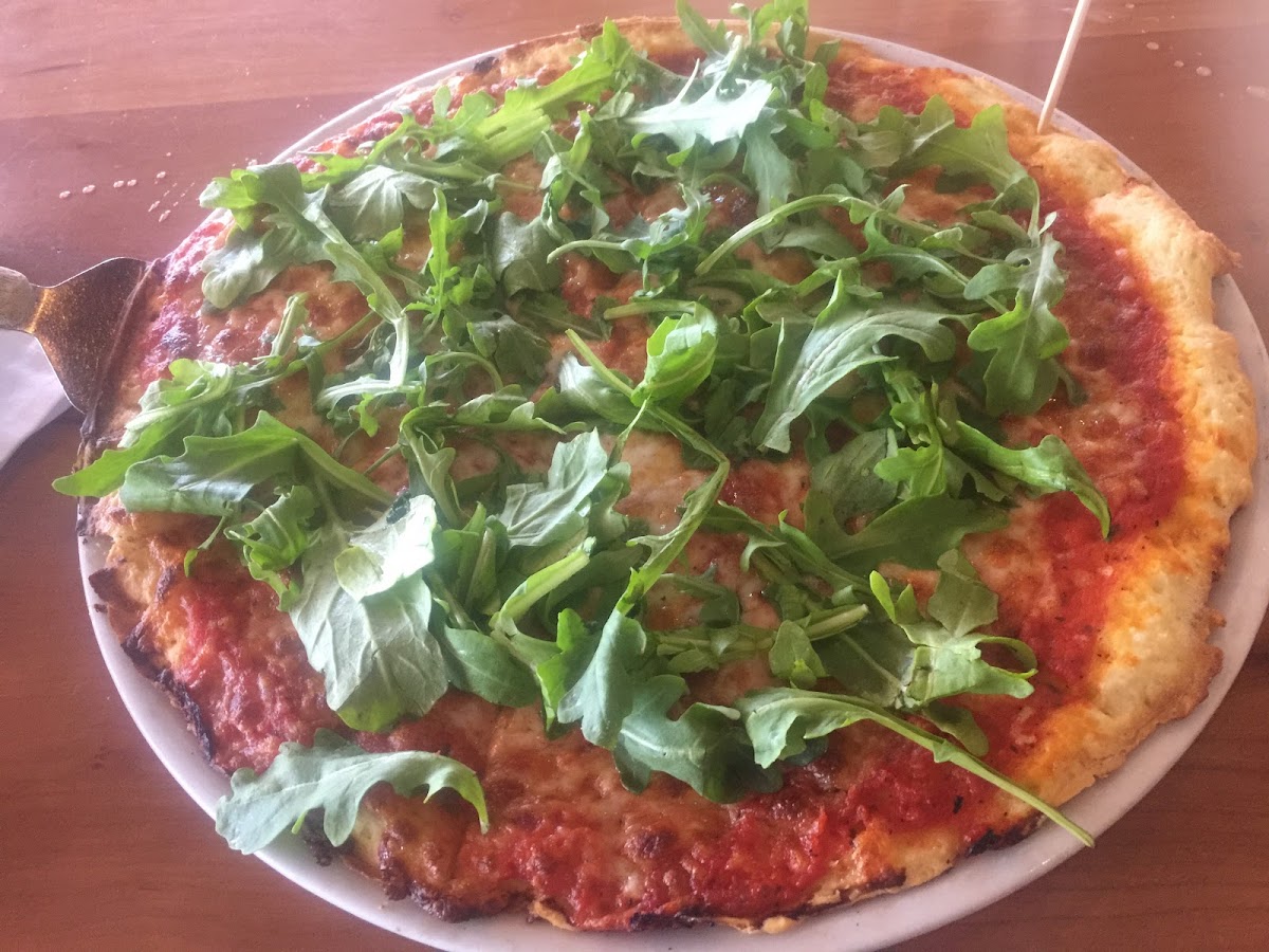 Gluten free pizza with arugula