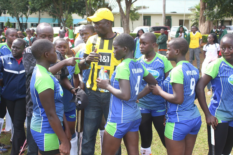 Nyamira Girls hockey coach Eliakim Obondo gives instructions to his team during a past competition