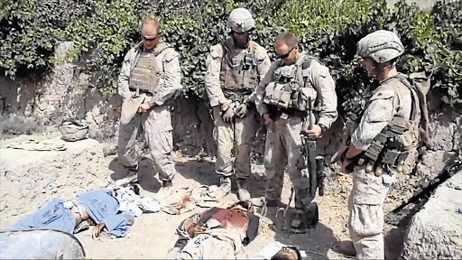 A still image taken from an undated YouTube video that shows what is believed to be US Marines urinating on the bodies of dead Taliban soldiers in Afghanistan.