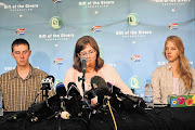 'WE HAVE LOST, BUT ...' Yolande Korkie, flanked by her children Pieter-Ben and Lize-Marie, speaking to the media in Johannesburg. The body of her murdered husband, Pierre, arrived in South Africa yesterday morning