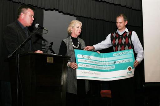 GRATEFUL: CHOC manager Debbie Kleinenberg, centre, receives a R150000 cheque from Selborne fundraisers Peter Mcloughlin and Royden Weiss Picture: SUPPLIED