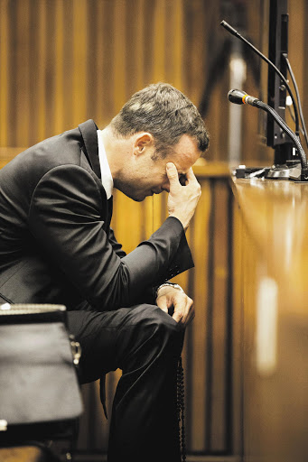 BROKEN: Oscar Pistorius sobs in the Pretoria High Court yesterday while a witness recounts what he found when he arrived at Pistorius's home on the night Reeva Steenkamp was killed