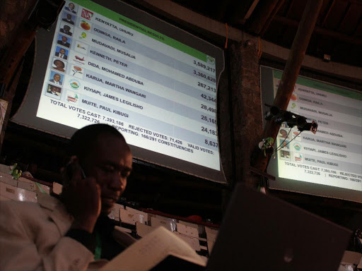 IEBC official follows results at the national tallying centre during the March 4, 2013 general election. /FILE