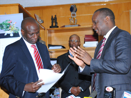 Treasury Cabinet Secretary Henry Rotich hands over documents of Ministry of Energy and Petroleum to the new CS Charles Keter. Photo/File