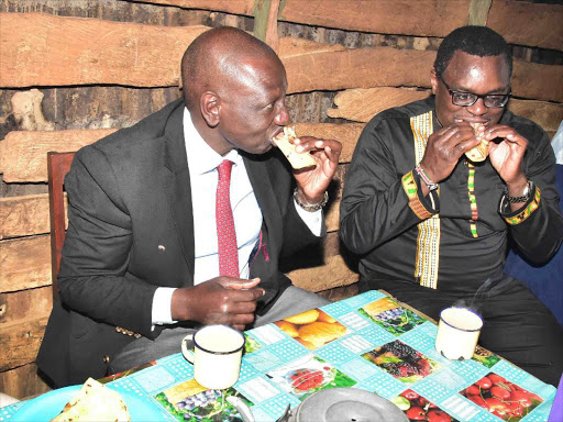 DP William Ruto and Senate Speaker Kenneth Lusaka take tea and chapati in a kiosk at Shianda market, Kakamega county, Sunday, November 4, 2018. /DPPS