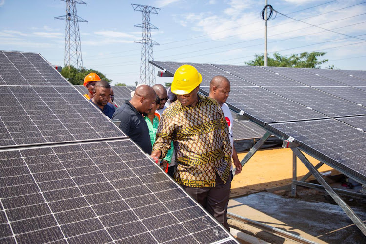 Gauteng premier Panyaza Lesufi leads a delegation in Alex to assess the progress of a micro-grid solar grid project.