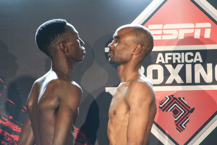SA flyweight champion Jackson Chauke, right, faces off with opponent Mustafa Mkupasi at the weigh-in on Wednesday.