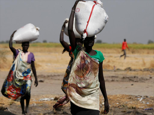 Women carry sacks of food in Nimini village, Unity State, northern South Sudan, February 8, 2017. /REUTERS