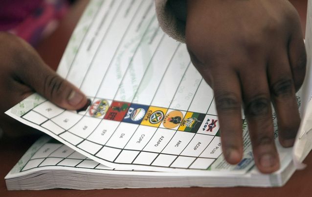 An Election Commission worker tears a ballot paper at a voting station during local municipal elections. Picture: EPA/KEVIN SUTHERLAND