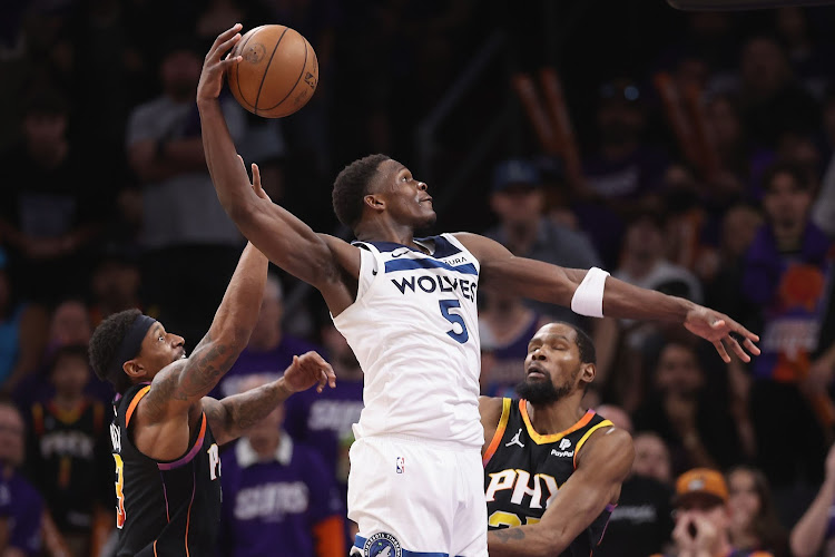Anthony Edwards of the Minnesota Timberwolves slam dunks the ball ahead of Bradley Beal and Kevin Durant of the Phoenix Suns during the second half of game four of the Western Conference First Round Playoffs at Footprint Center on April 28, 2024 in Phoenix, Arizona