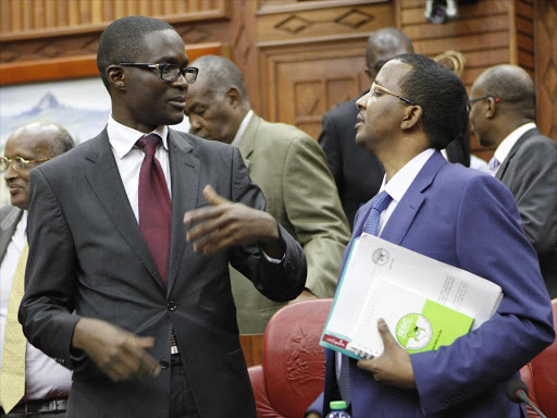 IEBC chair Isaack Hassan with CEO Ezra Chiloba confer when the commissioners appeared before IEBC select committee of parliament. Photo/Monicah Mwangi