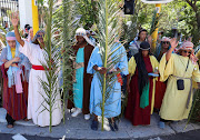 Christian worshippers hold palm leaves as they pray in front of parliament during the March of Hope ahead of Easter weekend in Cape Town, South Africa, March 27, 2024. 