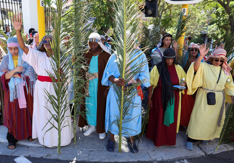 Christian worshippers hold palm leaves as they pray in front of parliament during the March of Hope ahead of Easter weekend in Cape Town, South Africa, March 27, 2024.