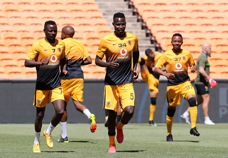 Anthony Akumu Agay and Lazarous Kambole of Kaizer Chiefs warm up before a Premiership match against SuperSport United at FNB Stadium on February 20 2021 in Johannesburg.