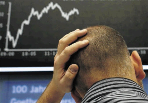 NAIL BITING: A trader watches the DAX index board at the Frankfurt Stock Exchange this week