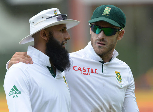 Hashim Amla and Faf du Plessis during the suspension due to rain during day 4 of the 2nd Test match between South Africa and West Indies at St. Georges Park on December 29, 2014 in Port Elizabeth, South Africa.