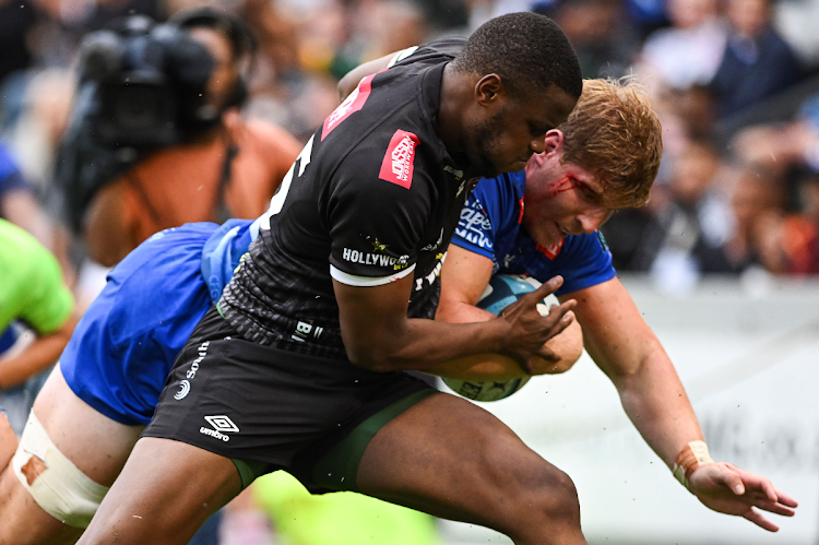 Sharks fullback Aphelele Fassi takes Evan Roos of the Stormers during the match at Hollywoodbets Kings Park Stadium on February 17, 2024.