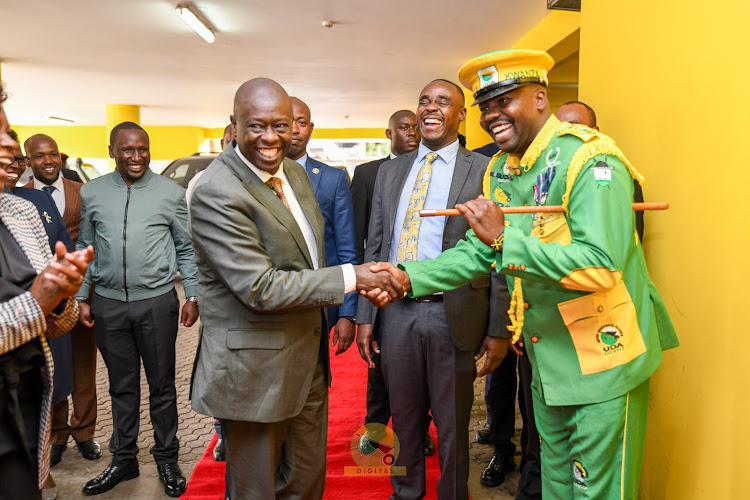 Deputy President Rigathi Gachagua greets UDA guard at the headquarter on April 15, 2024.