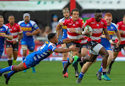 Madosh Tambwe of the Emirates Lions gets away from Damian Willemse of the DHL Stormers on his way to score his first try during the Super Rugby match between Emirates Lions and DHL Stormers at Emirates Airline Park on April 07, 2018 in Johannesburg.