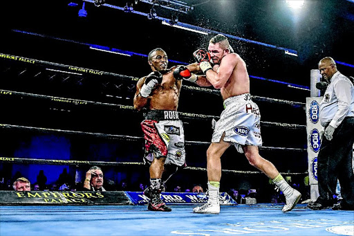 Thabiso Mchunu rattles Johnny Muller with a left punch in their their SA and ABU cruiserweight championship fight on Saturday night. /Nick Lourens