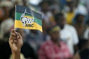 Hand holding an ANC flag. 