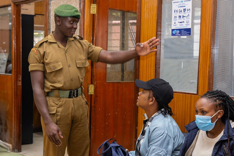 A security officer isssues guidelines to Kenyans who were seeking services at Nyayo House on May 6, 2024.