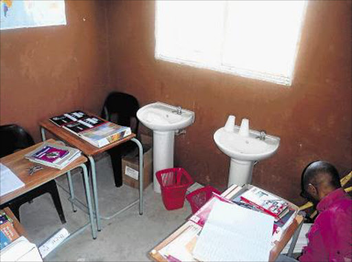 SMELLY SETUP: Teachers at Esethu Primary School use the toilet as a staffroom. Pupils go in and out of the toilets as the teachers do their work