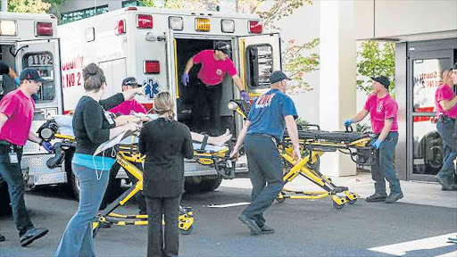 TRAGEDY REPEATED: A patient is taken into the emergency room in Roseburg, Oregon, after a deadly shooting at Umpqua Community College on Thursday left nine dead Picture: AFP