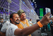 US actor Will Smith poses for a photo with a fan at the F1 Grand Prix of Saudi Arabia.