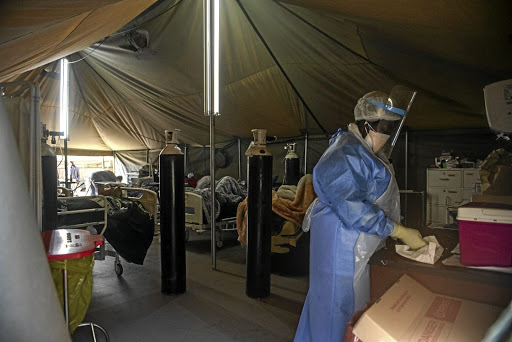 Professional healthcare workers in a tent dedicated to the treatment of possible Covid-19 coronavirus patients at the Tshwane District Hospital in Pretoria.