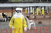 PROTECTIVE GEAR: Medicins Sans Frontieres health workers prepare at  an isolation camp in Liberia  PHOTO: REUTERS