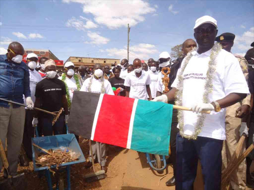 west Pokot governor Simon Kachapin flagging off the clean up exercise at Makuatano town