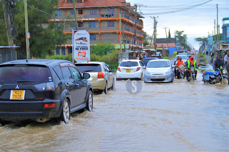 Vehicles wade through the flooded Syokimau-Katani road in Machakos County on Sunday, April 21, 2024.