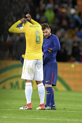 Lionel Messi and Wayne Arendse of Mamelodi Sundowns exchange jerseys.