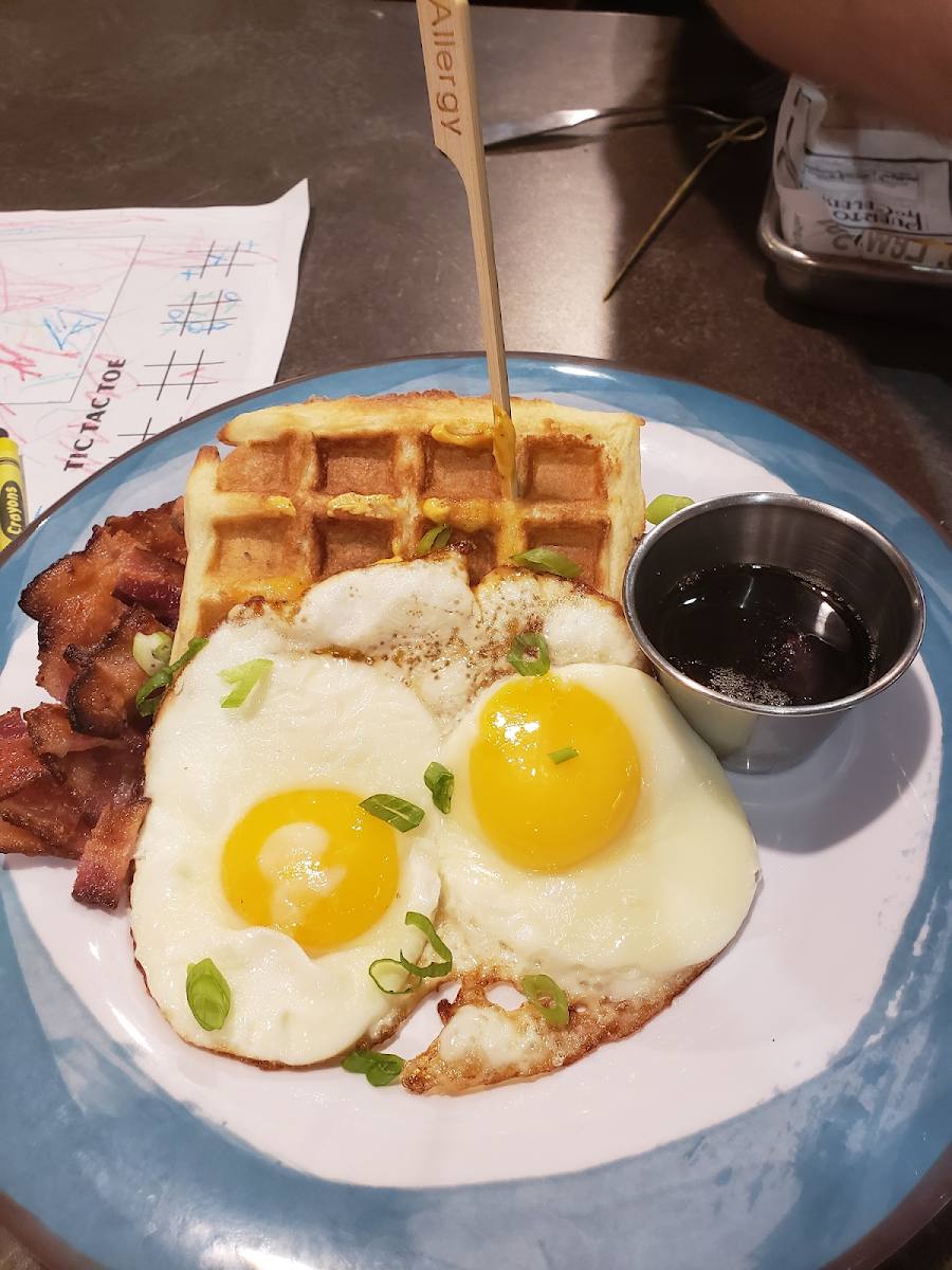 Chicken and waffle with eggs and bacon