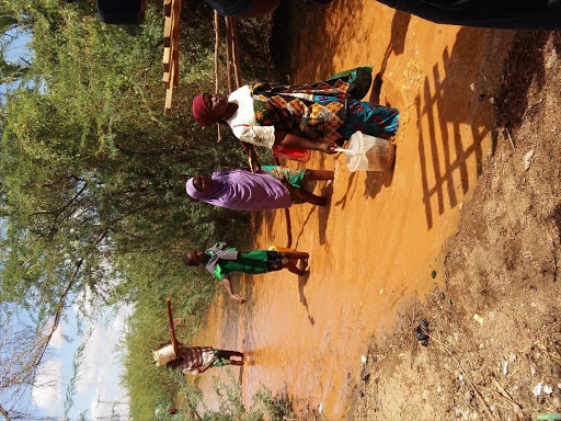 Residents of Bakuyu village, Garissa county, wade through floodwaters / STEPHEN ASTARIKO
