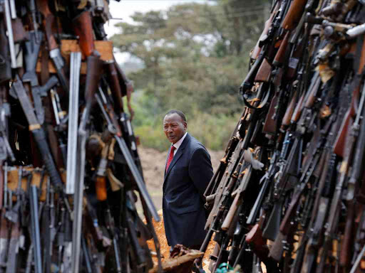 Kenya's Interior Cabinet Secretary Joseph Nkaissery inspects an assortment of guns during a public destruction of 5250 illicit firearms and small weapons, recovered during various security operations in Ngong hills near Kenya's capital Nairobi, November 15, 2016. REUTERS